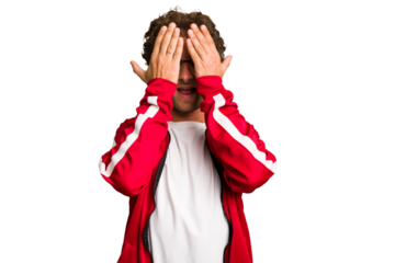 Young curly smart caucasian man cut out isolated having fun covering half of face with palm.