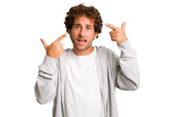 Young curly smart caucasian man cut out isolated showing a disappointment gesture with forefinger.