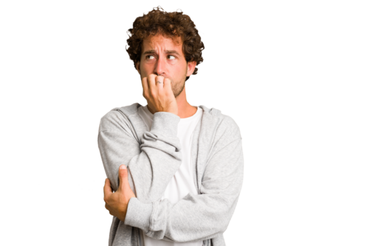 Young curly smart caucasian man cut out isolated biting fingernails, nervous and very anxious.