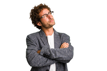 Young curly smart caucasian man cut out isolated dreaming of achieving goals and purposes