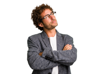 Young curly smart caucasian man cut out isolated dreaming of achieving goals and purposes