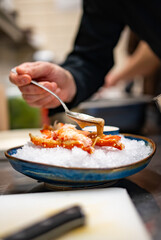 Obraz na płótnie Canvas chef cooking crab legs with caviar on kitchen
