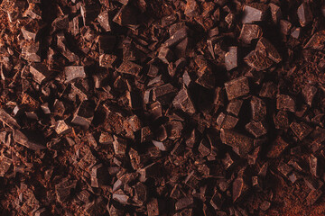 Flat lay view of dark chocolate chopped. Texture of cracked chocolate with copy space.