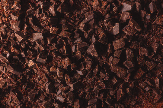 Flat lay view of dark chocolate chopped. Texture of cracked chocolate with copy space.