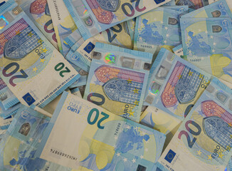pile of twenty euro bills spread out on a table. foreground. top view. inflaction
