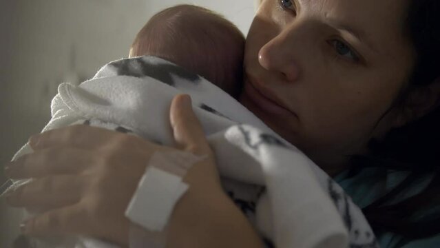 Mother Love and Skin-to-skin contact, woman holding newborn delivered baby after labour