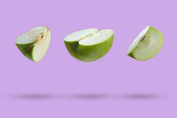 Sliced ​​apple in the air on a lilac background. Food levitation.