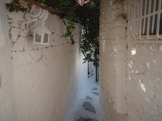 Fototapeta premium Marmaris is resort town on Turkish Riviera, also known as Turquoise Coast. Beautiful streets of old Marmaris. Narrow streets with stairs among houses with white bricks, green plants and flowers