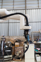Close-up of automatic robot arm system welding machine in the industry factory. Industry robot manufacturing technology