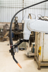 Close-up of automatic robot arm system welding machine in the industry factory. Industry robot manufacturing technology