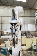 Close-up of automatic robot arm system welding machine in the industry factory. Industry robot manufacturing technology