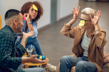 Group of three people involved in playing a guessing gam