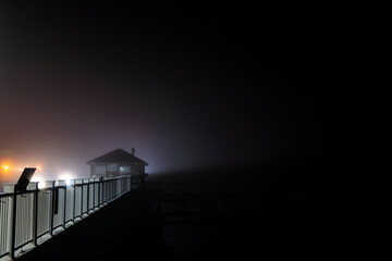 Solomons Island, Maryland USA A pier in the fog on the Patuxent river at night.