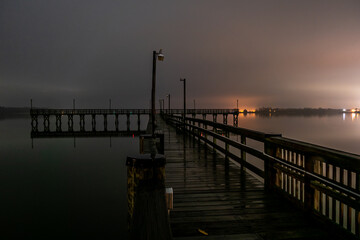 Fototapeta na wymiar Solomons Island, Maryland, USA A pier on Patuxent river at night looking towards the Chesapeake Bay.