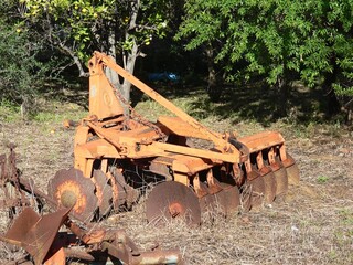 Old rusty cultivator on a farm