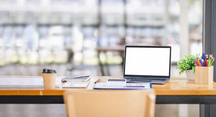 Background image of Laptop or notebook with blank screen on service counter in blurry background with parcel delivery office express, EMS.