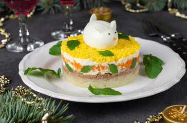 Puff salad Mimosa for the New Year with canned tuna, potatoes and carrots, decorated bunny from egg