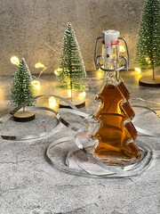 Christmas liqueur with spices. It goes perfectly with gingerbread. A bottle in the form of a Christmas tree. Decorative table decoration.