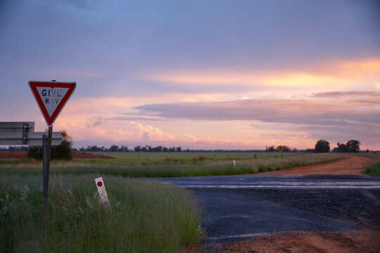 Roadside signage with dramatic sunset