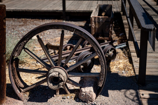 Detail of an old wagon wheel decorating the entrance of the house of the wild west