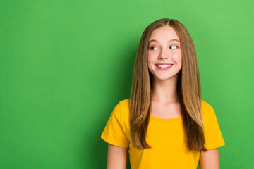 Portrait of cheerful adorable person beaming smile look interested empty space isolated on green color background