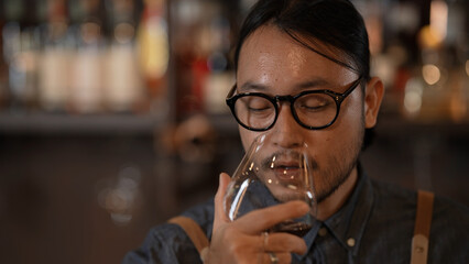 Night club concept of 4k Resolution. Bartender smiling confidently in a liquor store. A group of specialized clubs that sell alcoholic beverages.