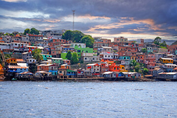 Picture of a housing estate in manaus with colorful houses taken from the Amazon River