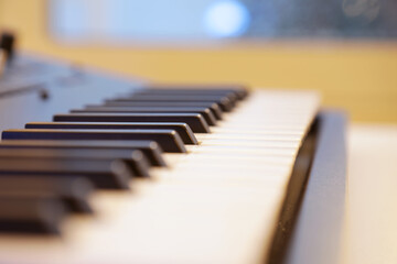 Keyboard keys close up. Synthesizer piano deck ready to be played and for recording music. Professional equipment for studio production and live performances. Music production and performance concept.