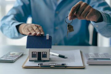 Real estate agent holding house keys for his client after contract signing Move house or rent Home...