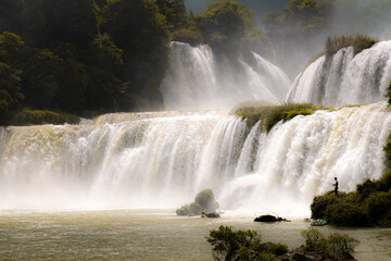 Gorgeous Detian Falls in Guangxi, China and Banyue Falls in Vietnam with fisherman 