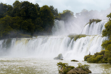 Obraz premium Bangioc - Detian waterfall is locate at border of China and Vietnam, It's famous waterfall of both country. There are boat service tourist for see nearby the waterfall.