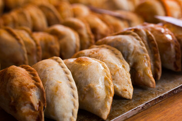 freshly baked empanadas with different fillings for sale