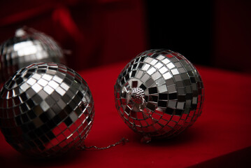 silver mirror balls on red gifts and black background