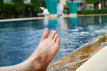 Asian woman swimming in the pool cramps in her toes,Sports exercising injury.