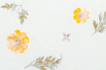 The Handmade recycled flower and leaf paper background.