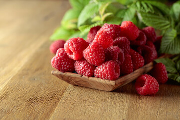 Ripe juicy raspberries with leaves.
