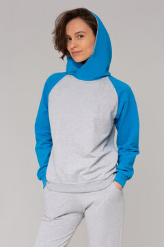 The beautiful girl in sportswear on a gray background. Healthy lifestyle. Mock up