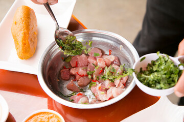 Preparing a delicious Peruvian sea bass ceviche in the fishing port of Chorríos in Lima.