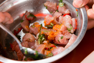 Preparing a delicious Peruvian sea bass ceviche in the fishing port of Chorríos in Lima.