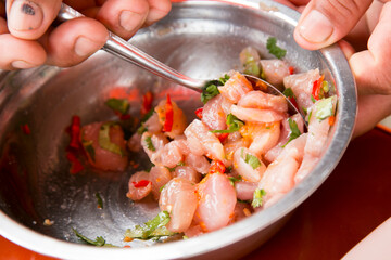 Preparing a delicious Peruvian sea bass ceviche in the fishing port of Chorríos in Lima.