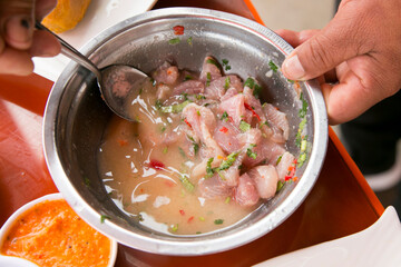 Preparing a delicious Peruvian sea bass ceviche in the fishing port of Chorríos in Lima.