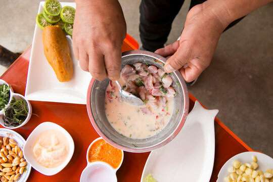 Preparing a delicious Peruvian sea bass ceviche in the fishing port of Chorr&iacute;os in Lima.