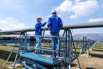 Maintenance engineer at solar farm stand on scissor lift routine inspection solar panel condition