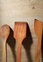 wooden kitchen utensils on wooden background