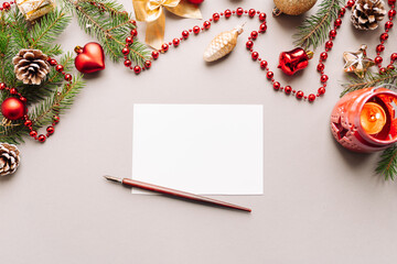 set of vintage dip pen, inkpot and blank paper sheet with envelope on white wooden table, Christmas decoration