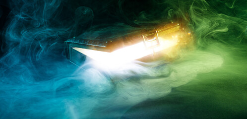 Mysterious glowing antique book on a dark background. Horizontal banner with copy space for popular...