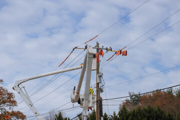 After hurricane of service men working power electrical lines support handling damage