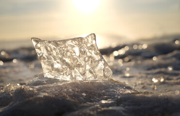 Piece of ice on winter landscape, sunset