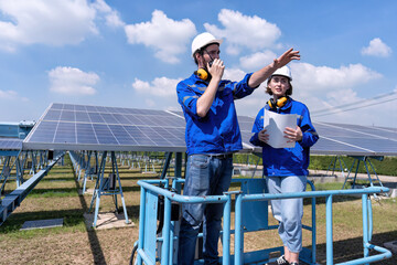 Maintenance engineer at solar farm stand on scissor lift inspection solar panel and radio report