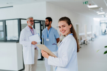 Portrait of young woman doctor at hospital corridor.